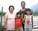 A family of the Bunong tribe, central Taiwan. The Bunong are an aboriginal tribe that predate the arrival of ethnic Chinese people to Taiwan. Here shown displaying the universal symbol for "hello." by William Gabrenya
